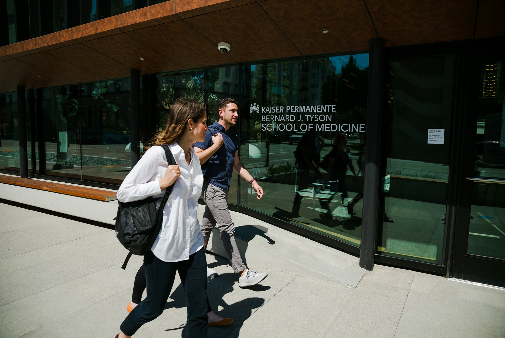 Woman and man students entering the School of Medicine